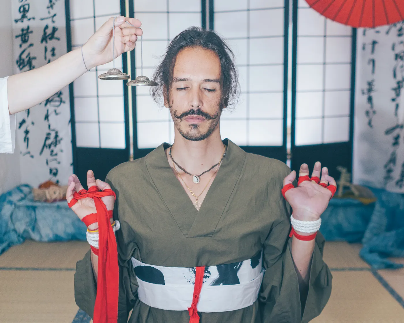 A guest resting on tatami after an AIDA METHOD rope meditation session in Tokyo, allowing the experience to settle.